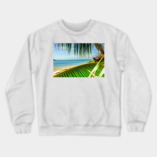 Tropical beach scene with palm fronds. Crewneck Sweatshirt